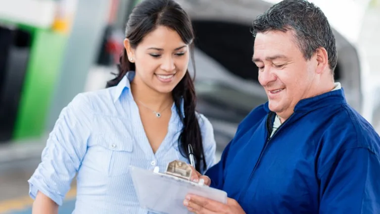 Customer and service representative reviewing paperwork